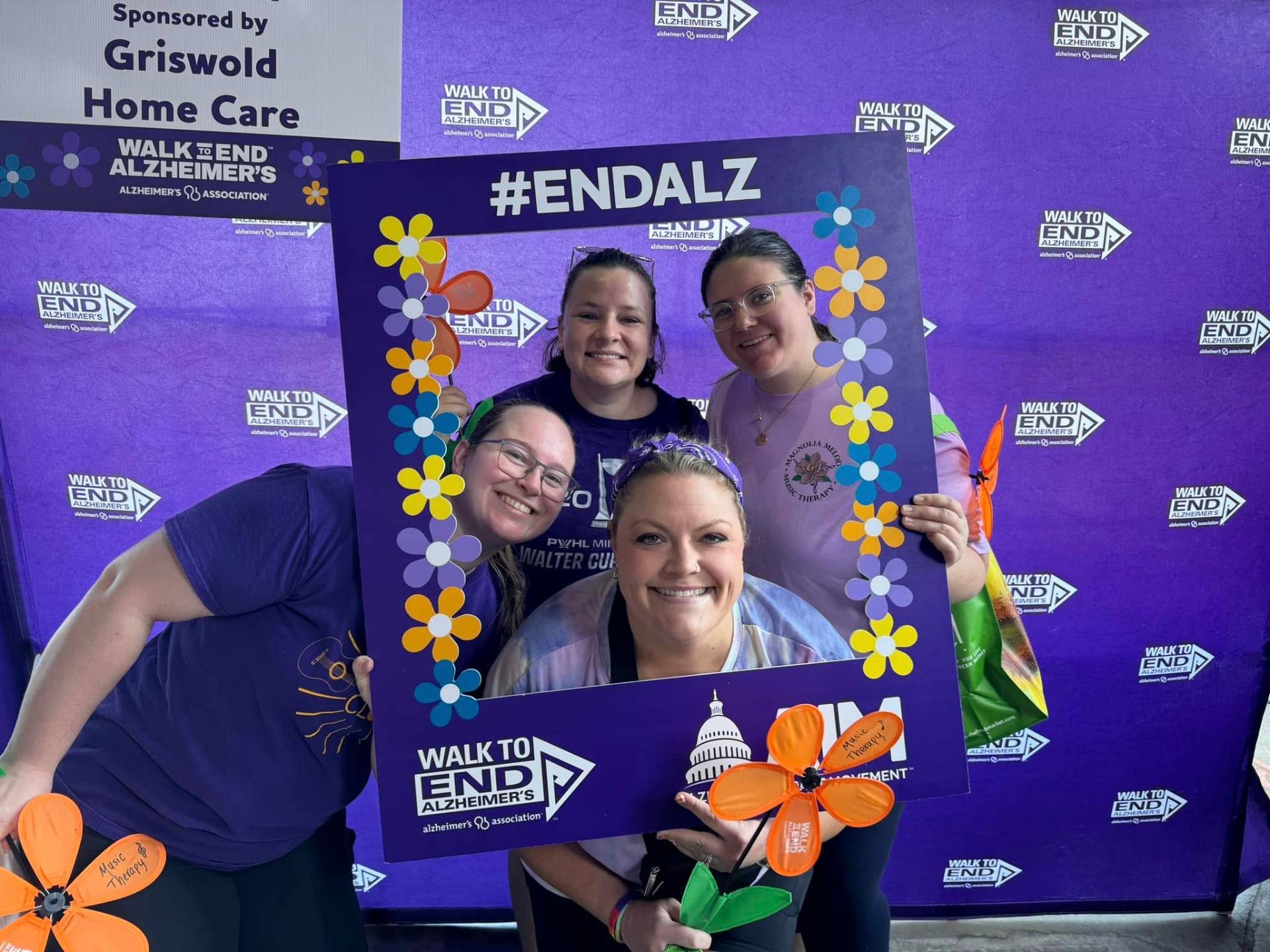 Team members in the #ENDALZ selfie frame