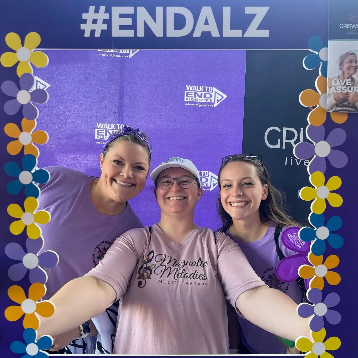 Three teammates at the #ENDALZ selfie station