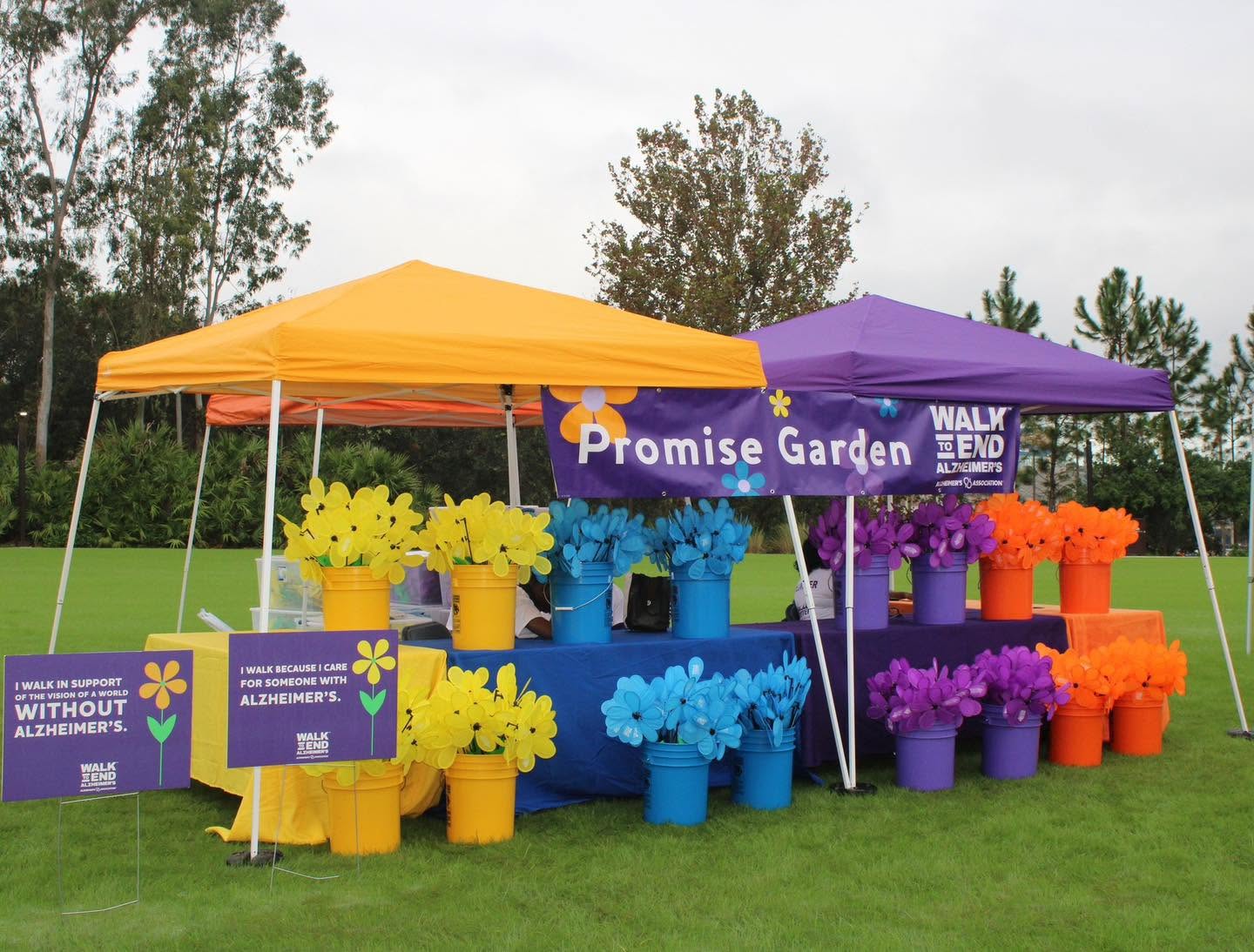 Promise Garden tent with buckets of yellow, blue, purple and orange flowers at the Walk to End Alzheimer's