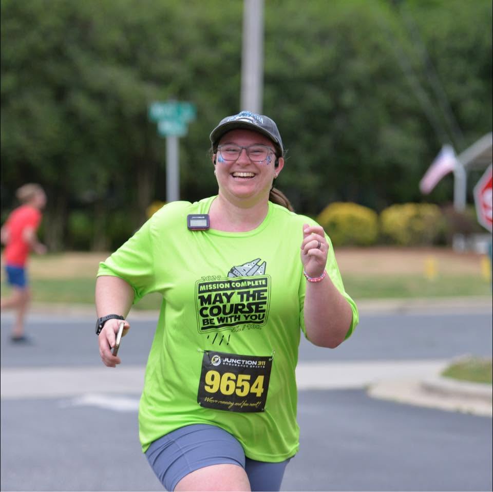 Mary Schneider, Team Captain, running at a race