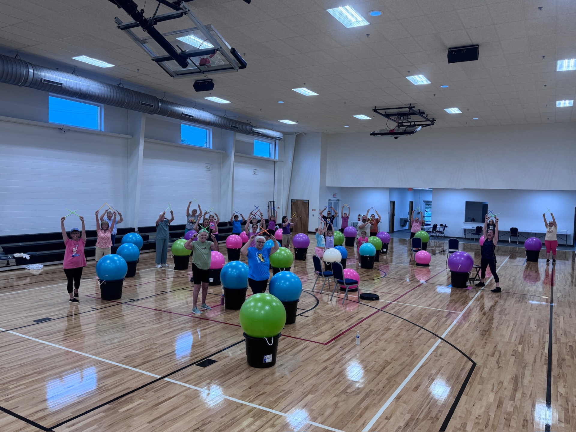 Drums Alive class participants drumming on yoga balls