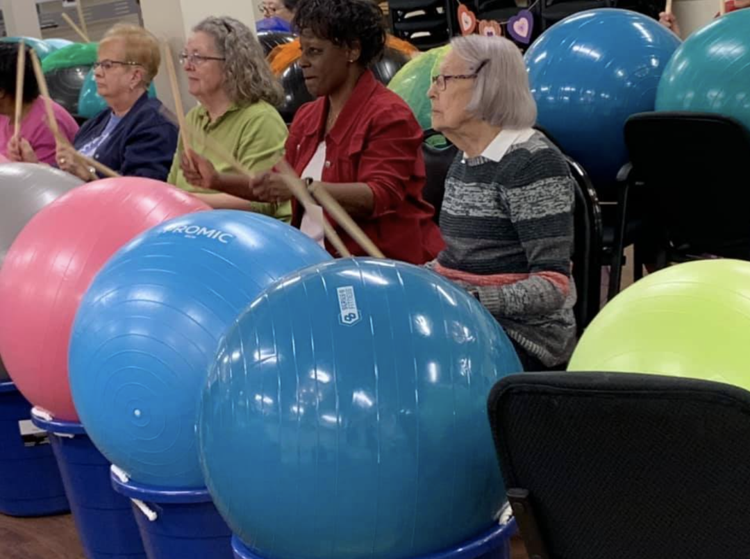Drums Alive class participants with yoga balls