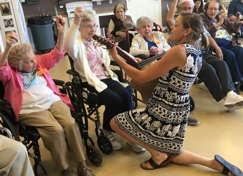 Music therapist engaging with a participant during a session
