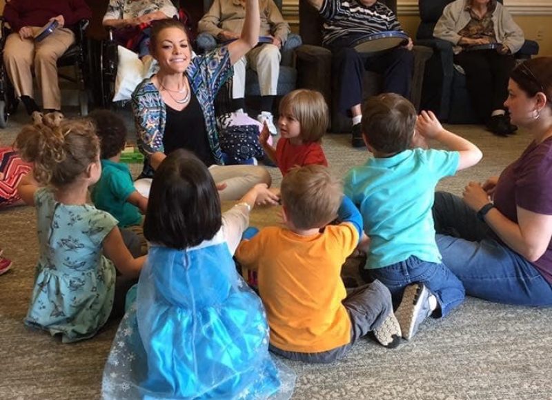 Children gathered in a circle for a group music session