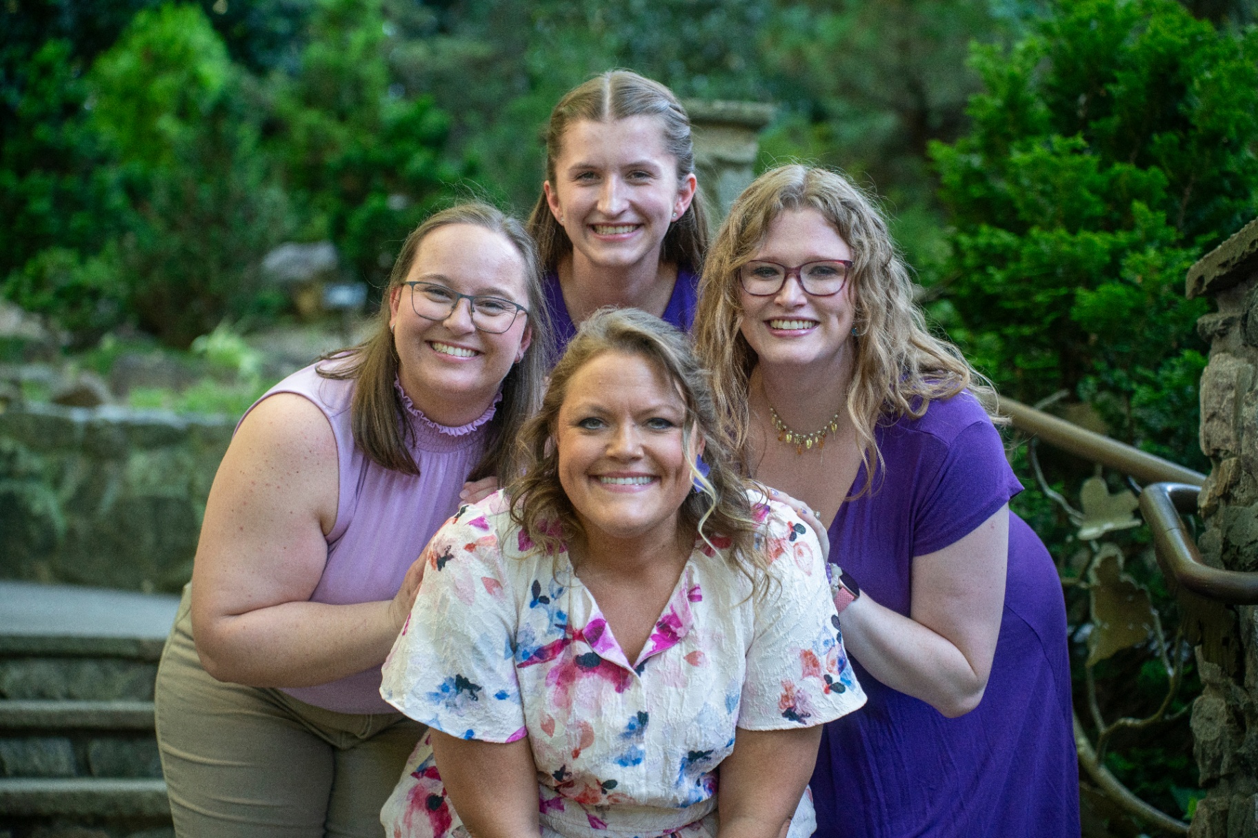 The Magnolia Melodies team of four music therapists together in a garden